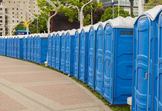 a row of portable restrooms set up for a large athletic event, allowing participants and spectators to easily take care of their needs in North Hills